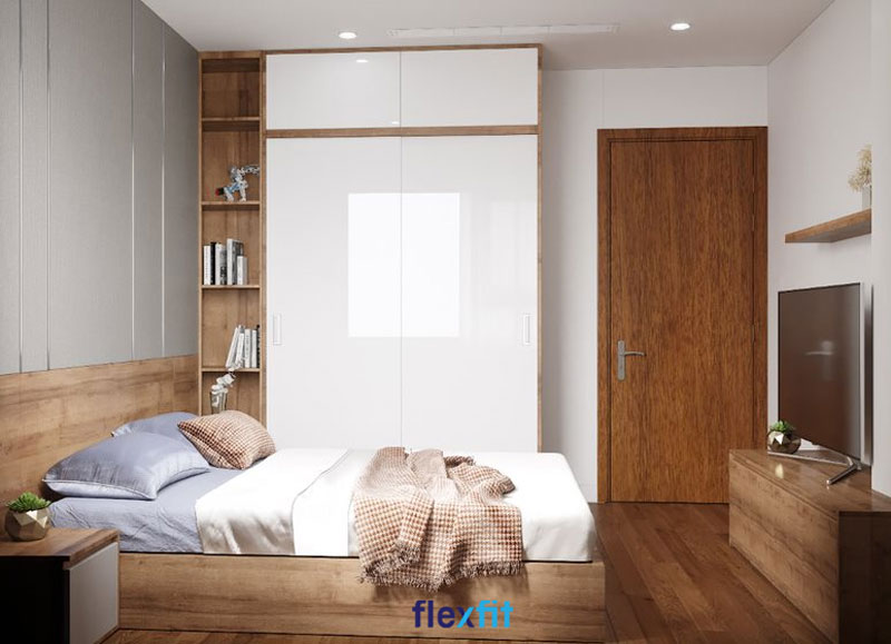Tủ quần áo lõi MDF phủ Acrylic màu trắng sáng bóng. Bên trái tủ là kệ trang trí nâu vân gỗ mang lại sự mới mẻ hơn cho không gian phòng.