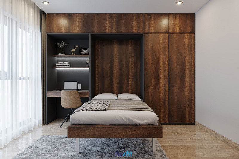 Giường ngủ âm tường thiết kế thông minh khi không dùng có thể gấp gọn giúp căn phòng trở nên thoáng rộng hơn. Giường còn được tích hợp với hệ tủ quần áo thiết kế kịch trần và bàn làm việc tạo thành hệ nội thất liền mạch, đa dụng.